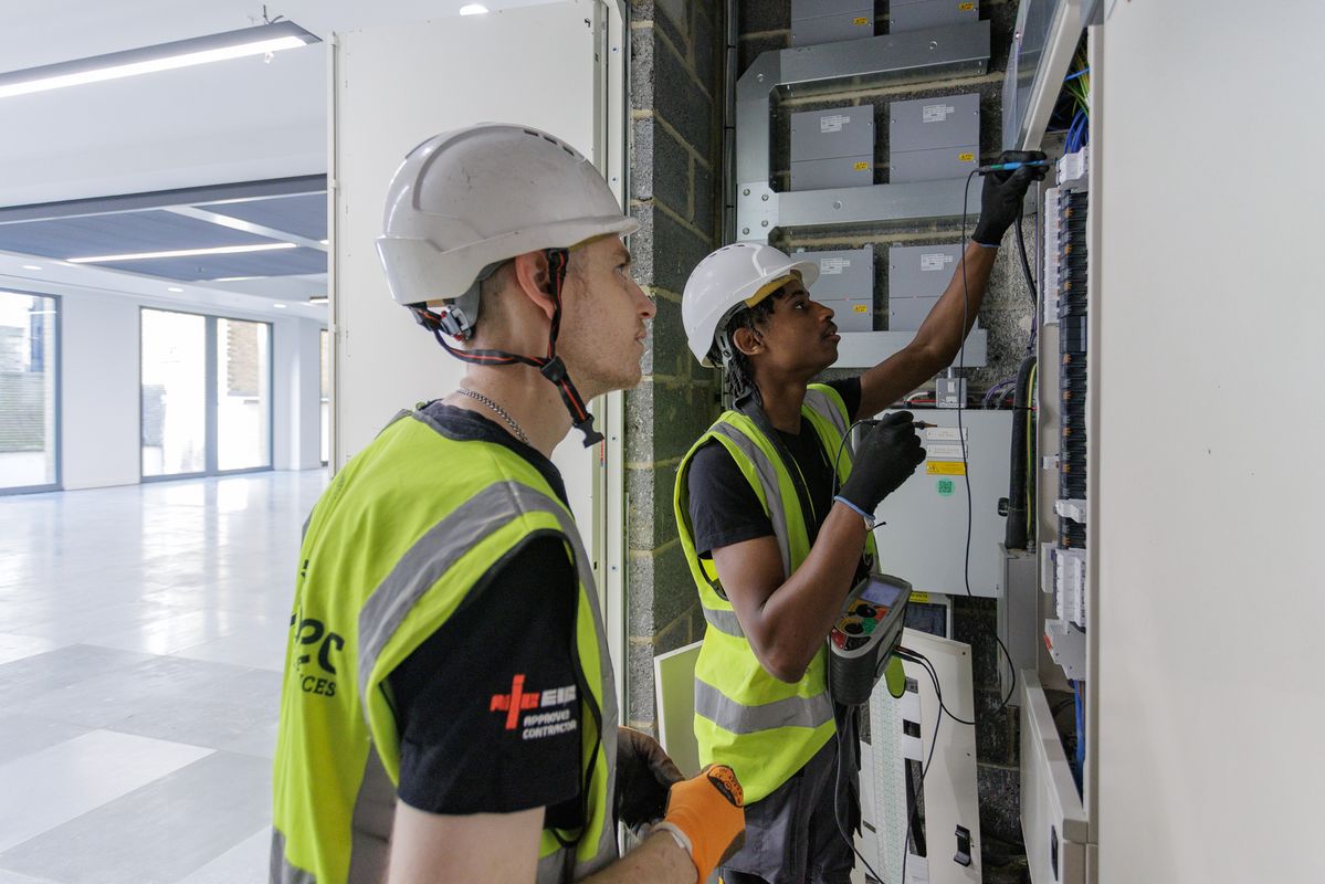 two electrician checking electrical wires